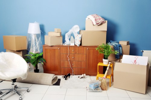 Packed moving boxes and furniture ready for transport in Shepherds Bush