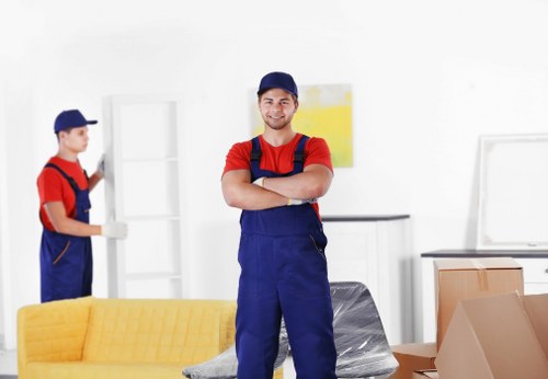 Local movers preparing fragile household items for transport