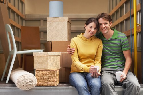 Professional movers using PPE and careful lifting techniques