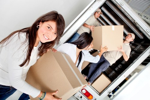 Professional movers handling furniture with care