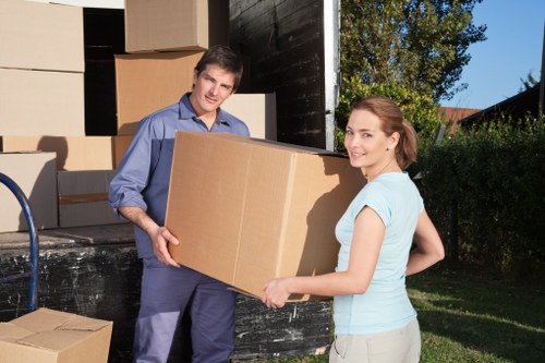Large household furniture being safely loaded for transport in West London